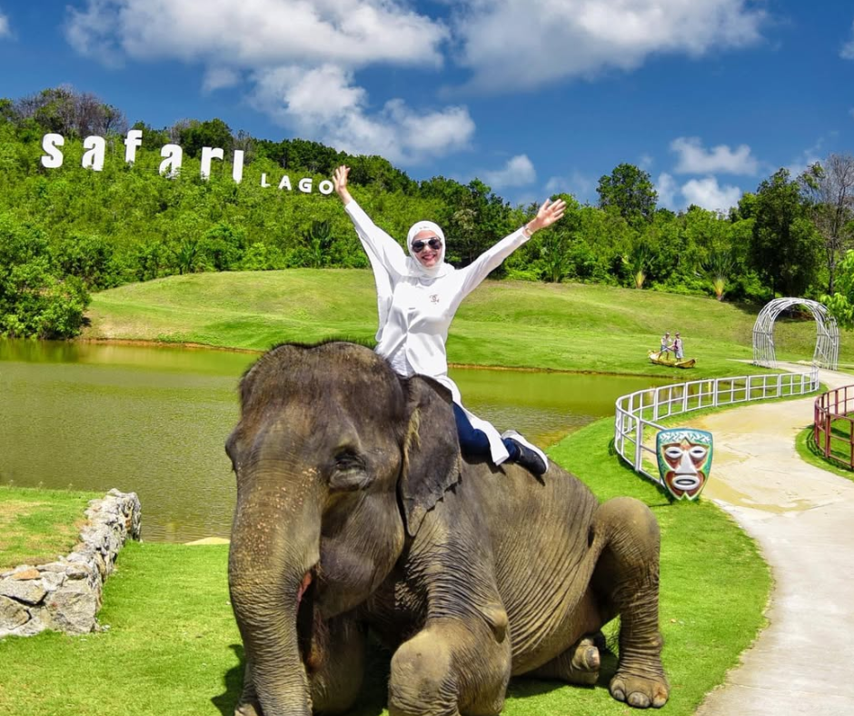Tourists riding an elephant during an animal encounter experience at Safari Lagoi, Bintan.