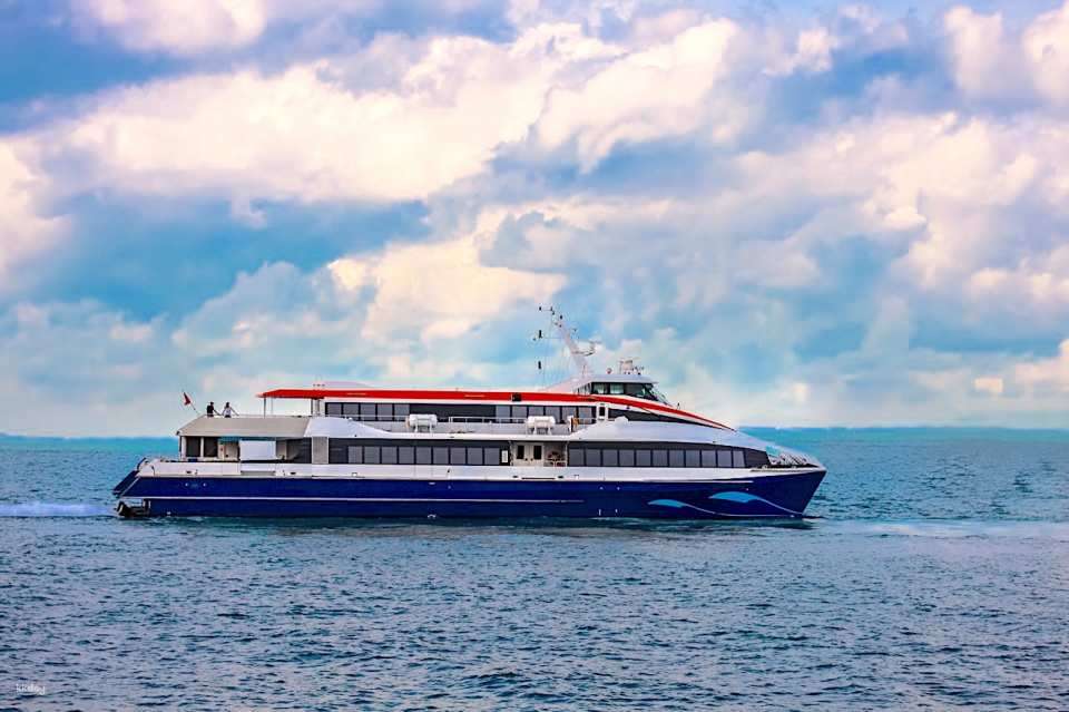Passengers boarding a high-speed ferry at the terminal for a trip from Singapore to Bintan Island, comparing Bintan vs Batam travel options.