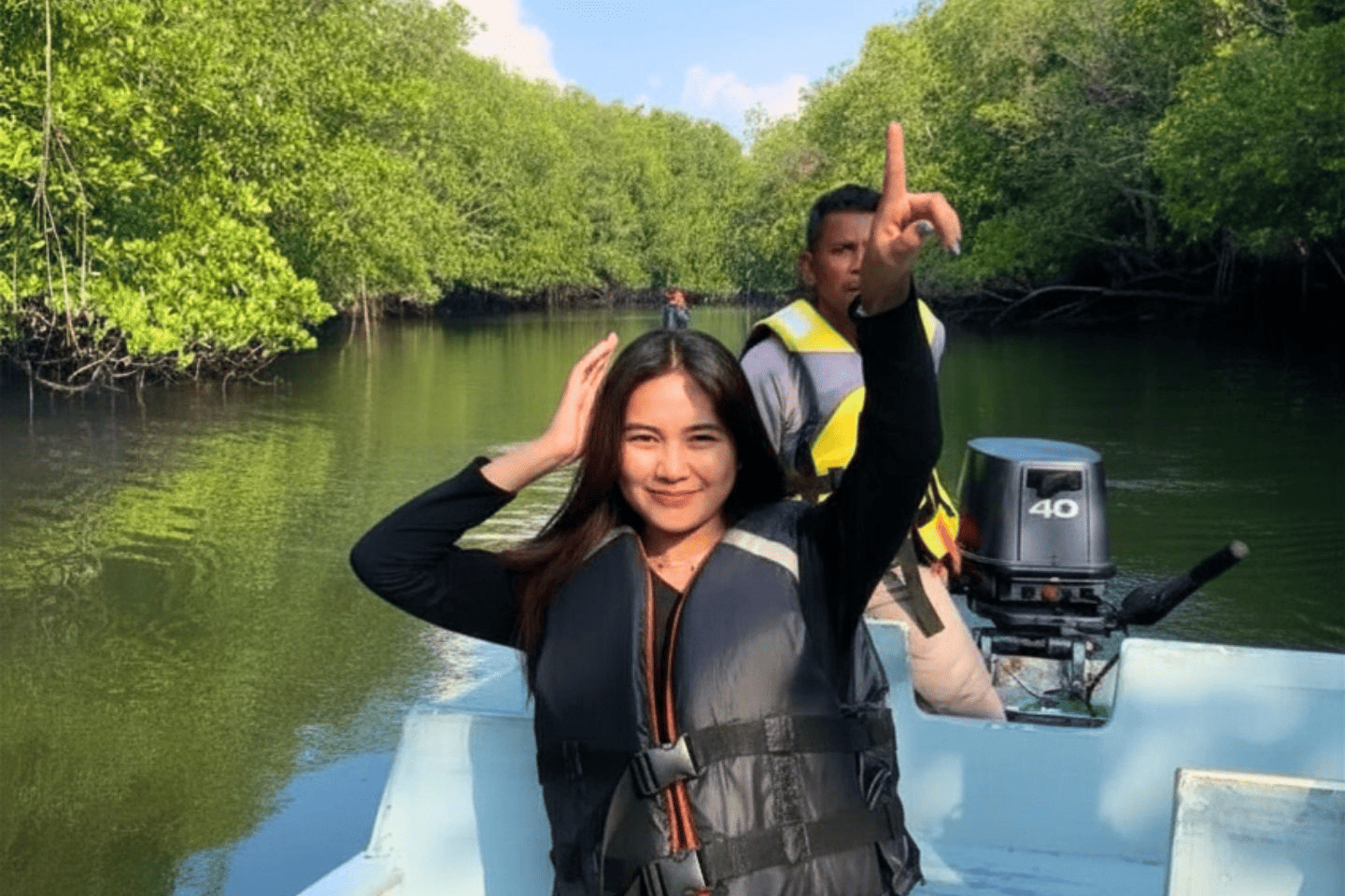 Tourists exploring the lush river ecosystem on a boat during our premium Bintan Tour Packages