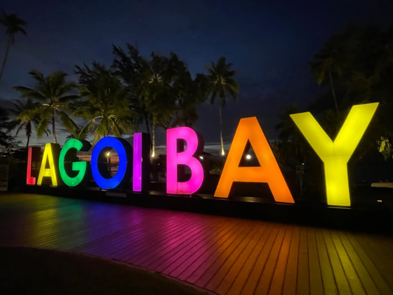 Scenic view of Lagoi Bay, Bintan with calm turquoise waters and a small boat near the shore.