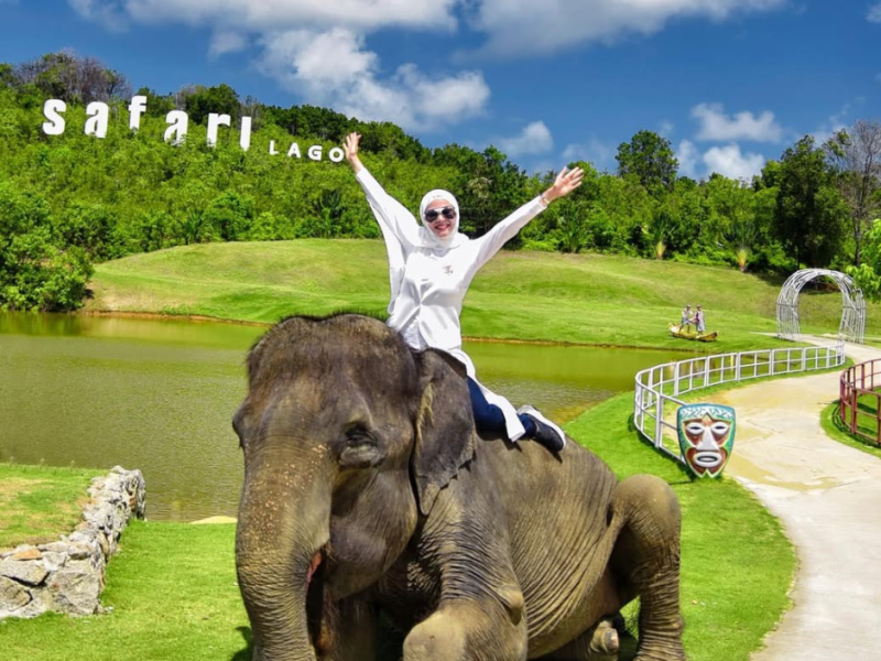 Safari Lagoi Tourists riding an elephant during an animal encounter experience at Safari Lagoi, Bintan.