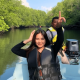 Tourists exploring the lush river ecosystem on a boat during our premium Bintan Tour Packages